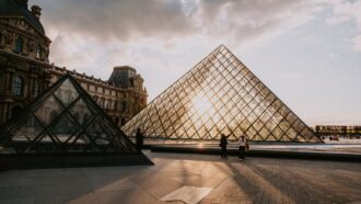 Paris and the Louvre museum's iconic pyramid at sunrise